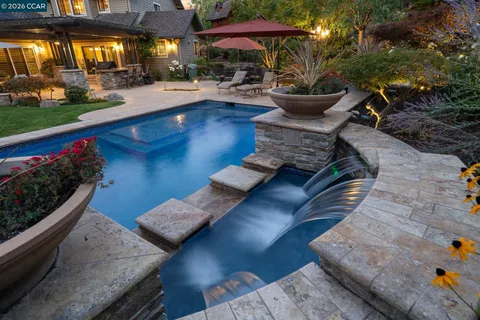 a swimming pool with outdoor seating and yard