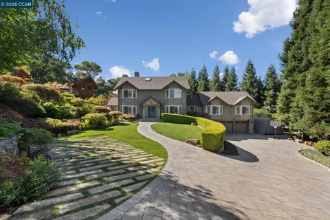 a view of a house with swimming pool and yard