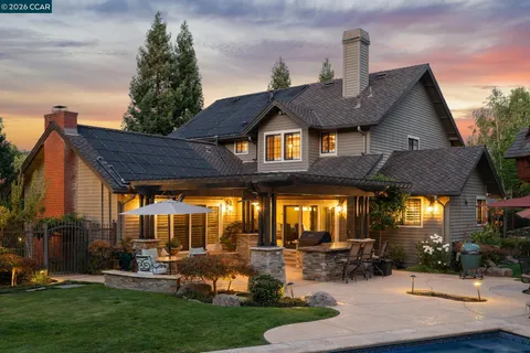 a view of a house with backyard and sitting area