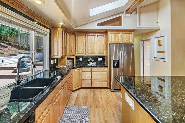 a view of a kitchen with a large window