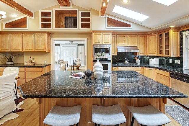 a kitchen with granite countertop a sink and a counter top space