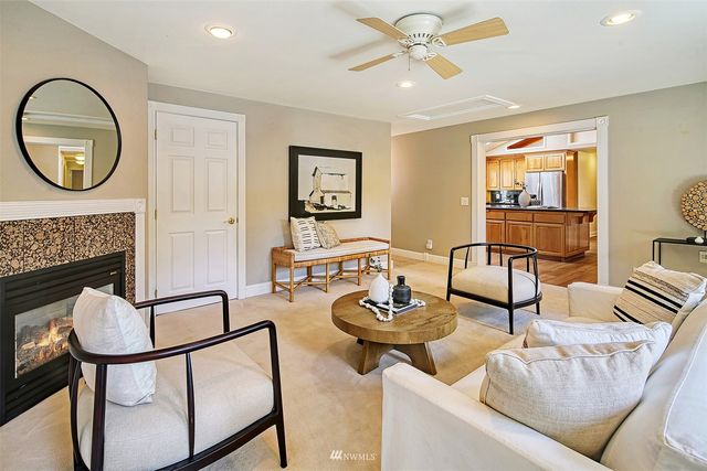 a living room with furniture a rug and a fireplace