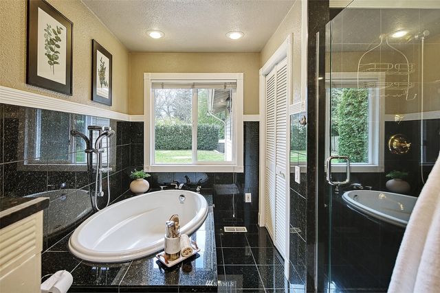 a bathroom with a sink a toilet a mirror and a tub