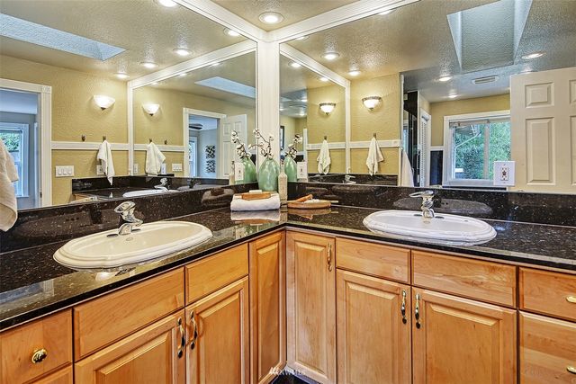 a bathroom with double sink and a mirror
