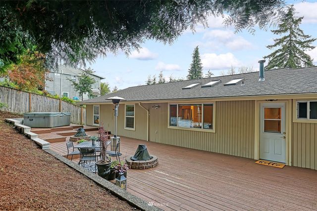 a view of a house with backyard and sitting area