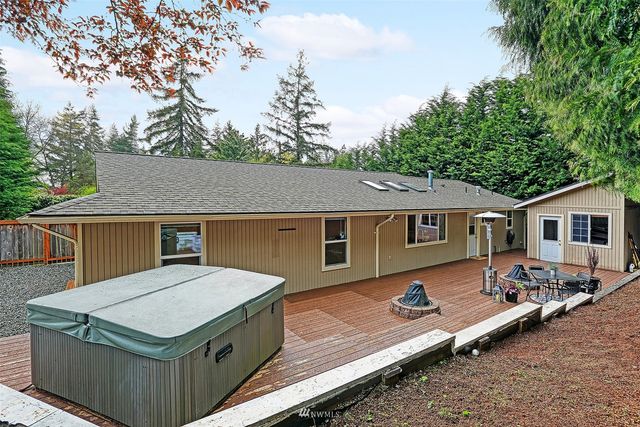 a terrace of a house with wooden fence next to a yard