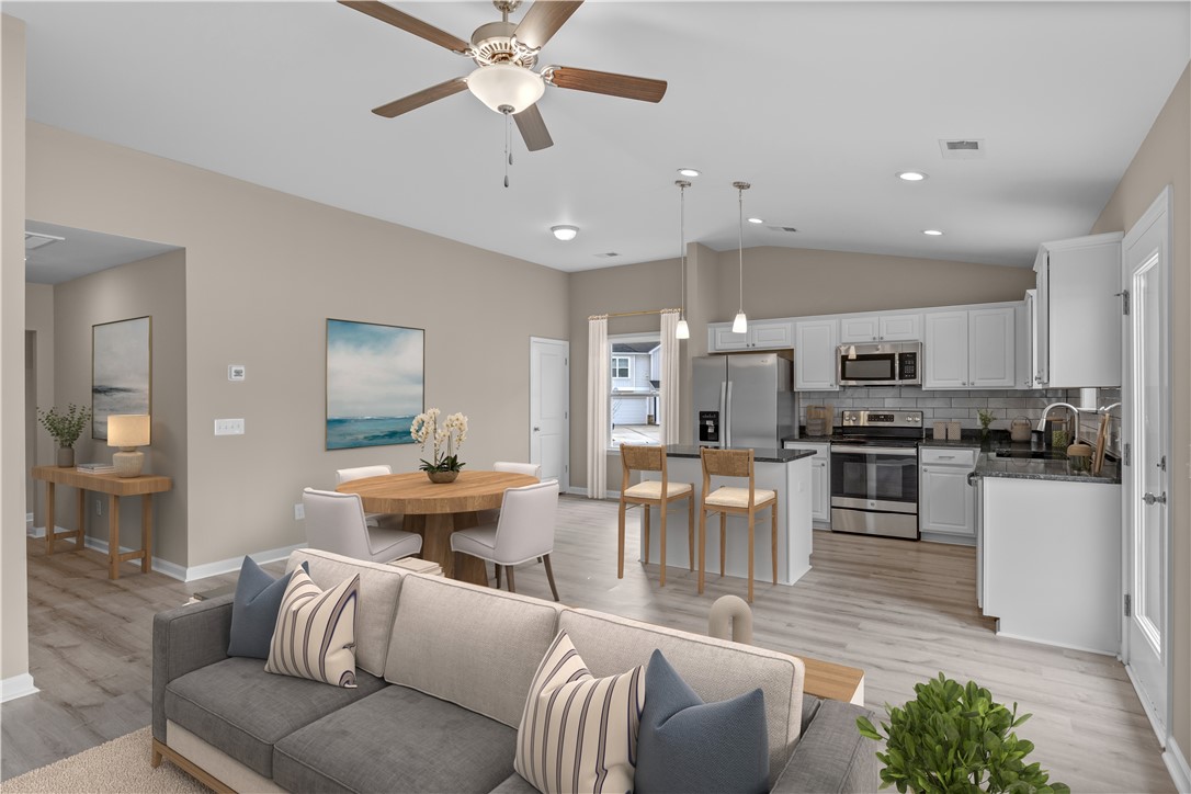 209 Celebration Avenue Anderson, SC 29625 - Photo 7 of 36 This open-concept living area seamlessly connects the kitchen and dining spaces.