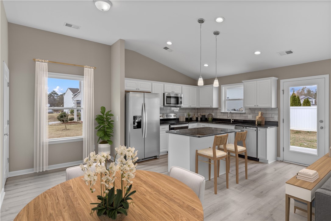 209 Celebration Avenue Anderson, SC 29625 - Photo 10 of 36 Bright and open, this inviting kitchen and dining area provides a perfect gathering space.