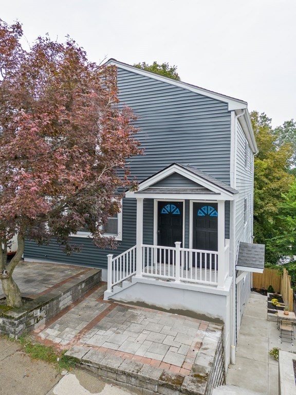 9-13 Sutherland Road, Unit 2 Arlington, MA 02476 - Photo 10 of 15 a front view of a house with a yard