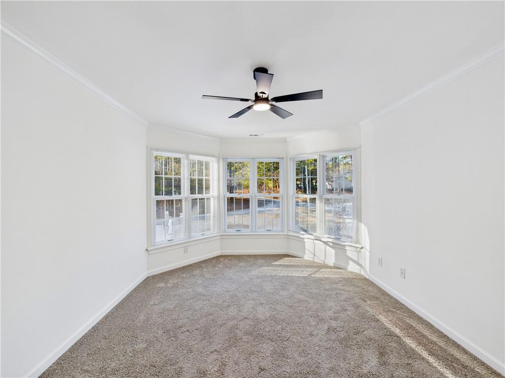 5302 Greenway Drive Villa Rica, GA 30180 - Photo 46 of 81 an empty room with chandelier fan and windows