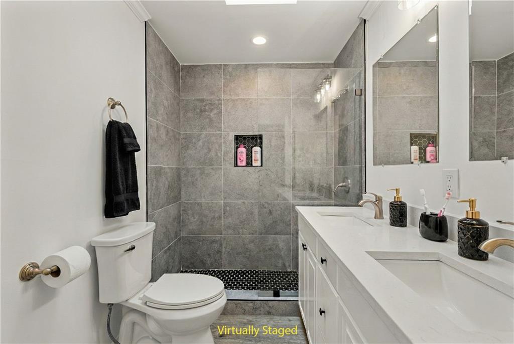 5302 Greenway Drive Villa Rica, GA 30180 - Photo 47 of 81 a bathroom with a double vanity sink toilet and shower