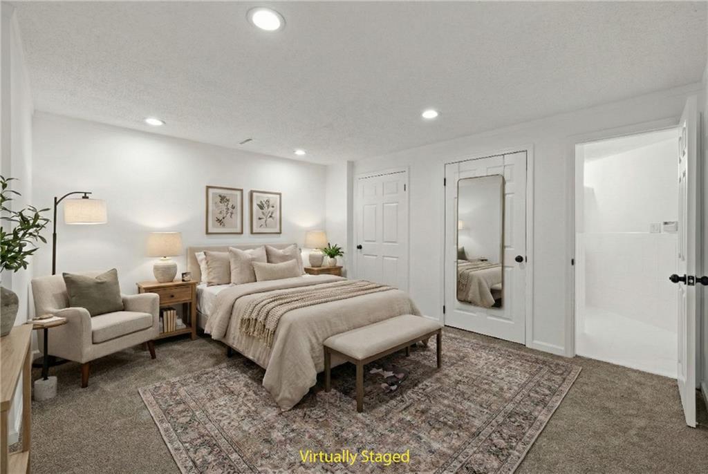 5302 Greenway Drive Villa Rica, GA 30180 - Photo 53 of 79 a spacious bedroom with a bed a couch and a dresser