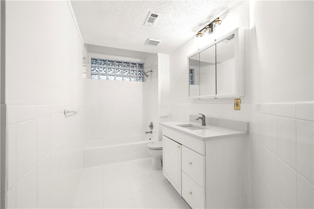 5302 Greenway Drive Villa Rica, GA 30180 - Photo 58 of 81 a bathroom with a granite countertop sink a toilet a shower and a mirror