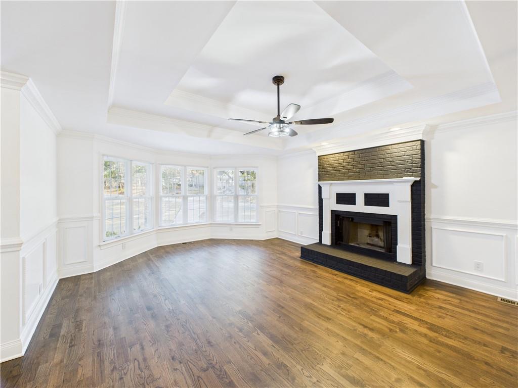 5302 Greenway Drive Villa Rica, GA 30180 - Photo 6 of 79 an empty room with wooden floor fireplace and windows