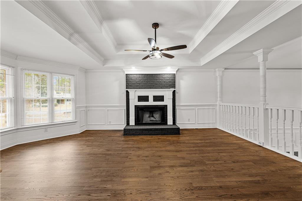 5302 Greenway Drive Villa Rica, GA 30180 - Photo 7 of 79 an empty room with fireplace wooden floor and windows