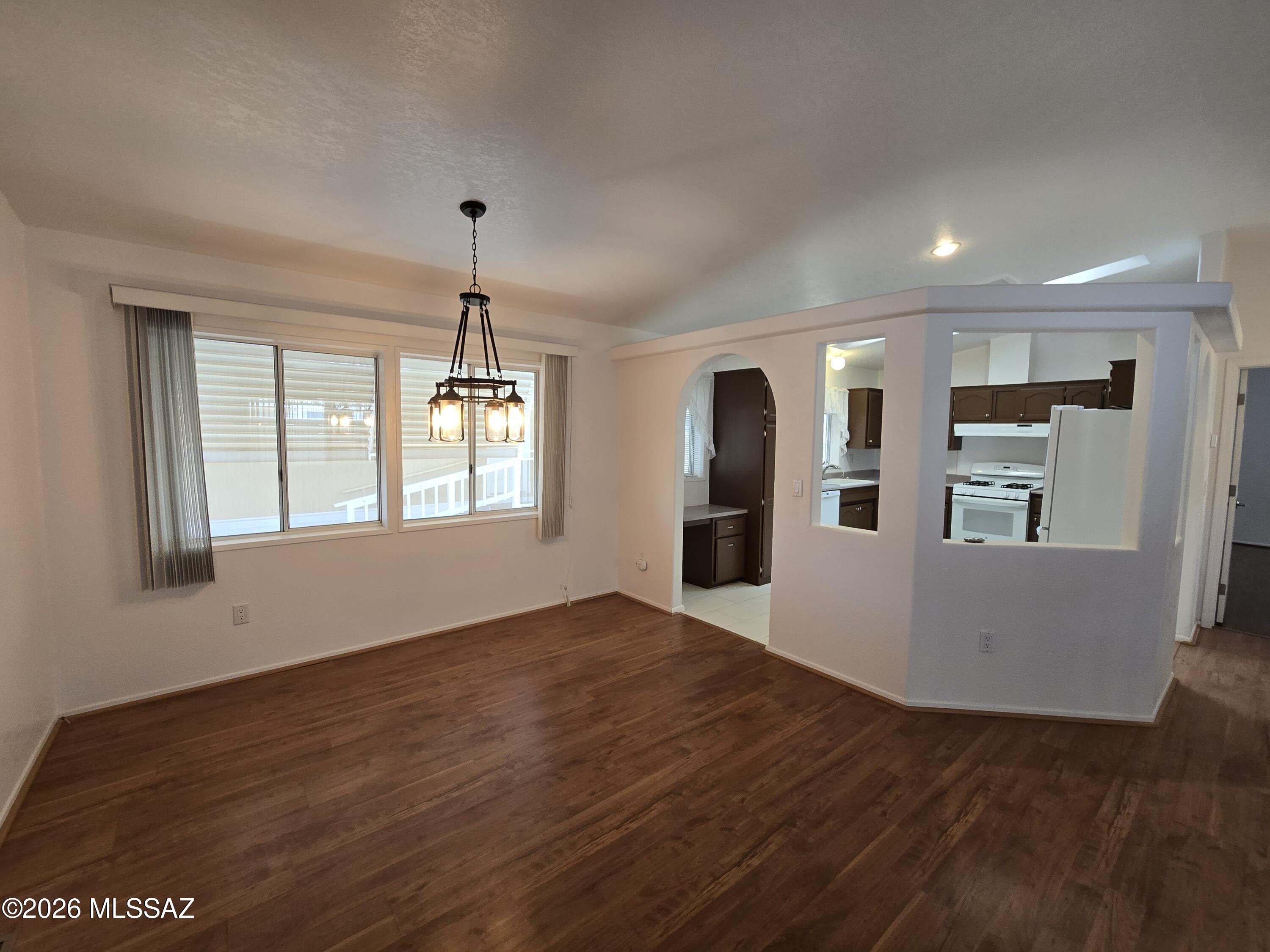 8401 South Kolb Road, Unit 61 Tucson, AZ 85756 - Photo 19 of 23 a view of an empty room with window and wooden floor