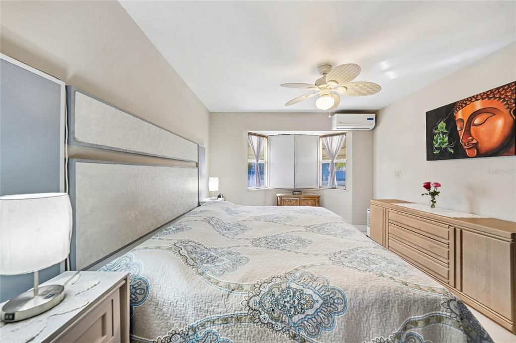 2930 Acline Road Punta Gorda, FL 33950 - Photo 13 of 29 a spacious bedroom with a bed and a flat screen tv