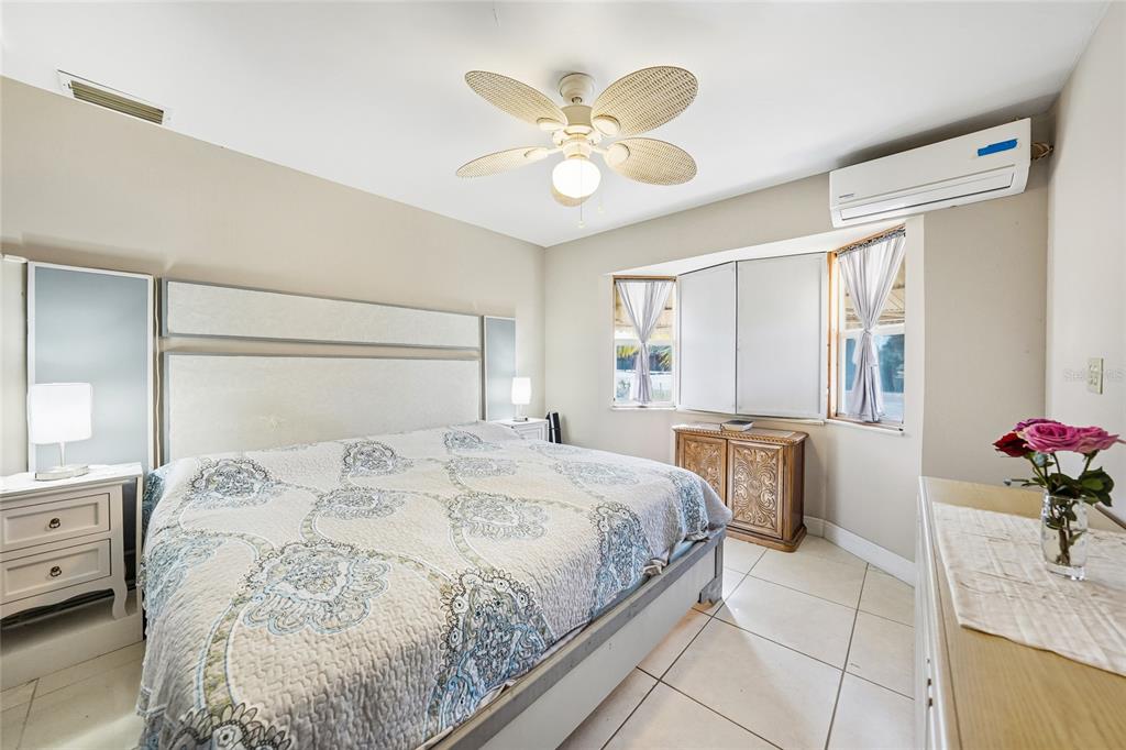 2930 Acline Road Punta Gorda, FL 33950 - Photo 14 of 29 a bedroom with a bed and a chandelier