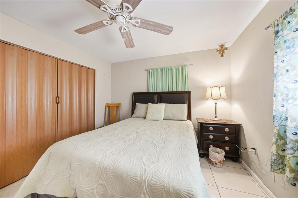 2930 Acline Road Punta Gorda, FL 33950 - Photo 19 of 29 a bedroom with a bed and a chandelier