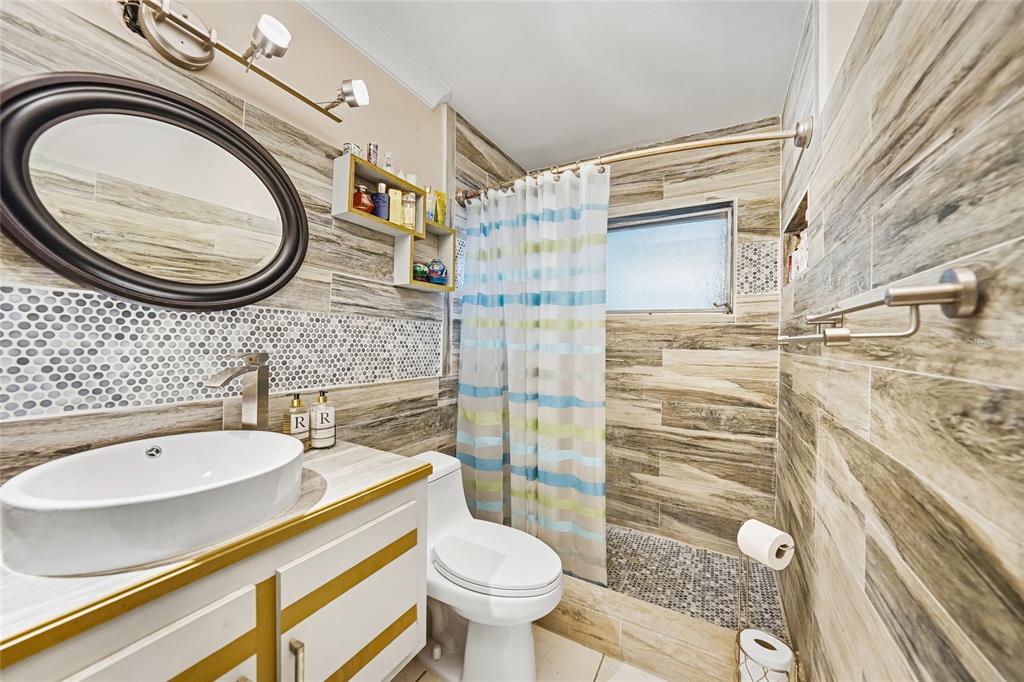 2930 Acline Road Punta Gorda, FL 33950 - Photo 21 of 29 a bathroom with a sink a toilet and a shower