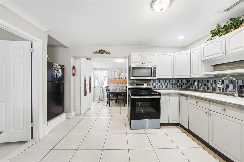 2930 Acline Road Punta Gorda, FL 33950 - Photo 7 of 29 a kitchen with stainless steel appliances granite countertop a refrigerator and a sink
