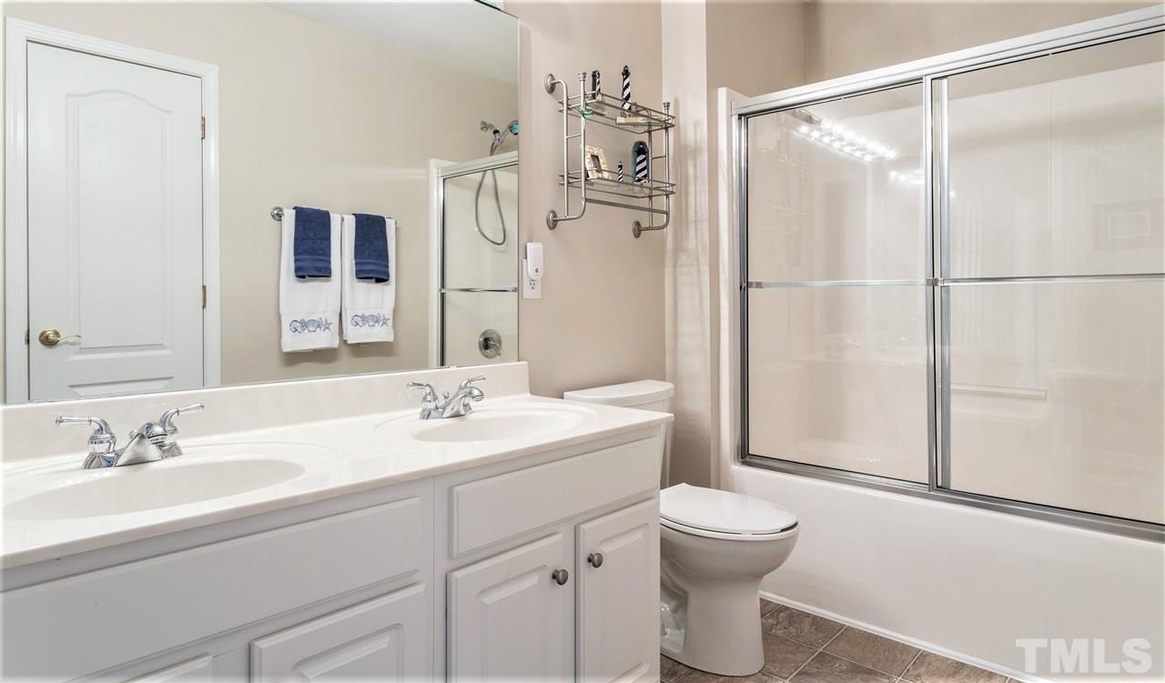 7718 Tori Trace Raleigh, NC 27613 - Photo 25 of 30 Bathroom has hall access and connects to upstairs 2nd bedroom.