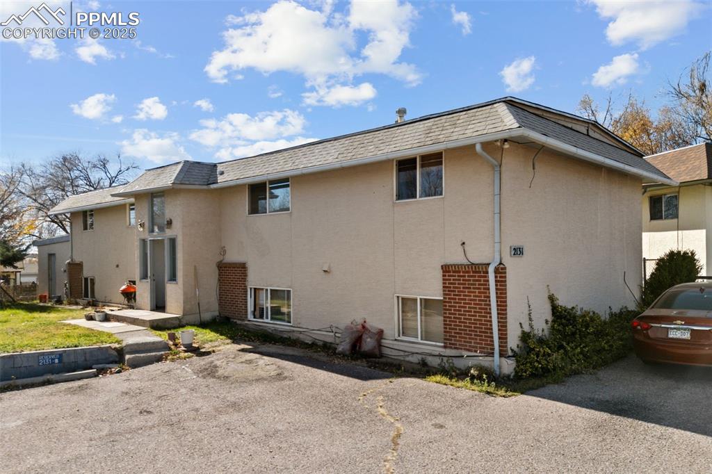 2131 Preuss Road, Unit A Colorado Springs, CO 80910 - Photo 1 of 17 a view of a house with backyard and garden