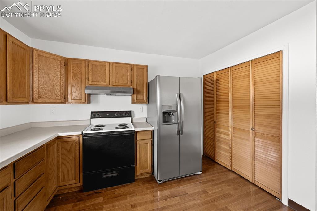 2131 Preuss Road, Unit A Colorado Springs, CO 80910 - Photo 11 of 17 a kitchen with stainless steel appliances granite countertop a refrigerator stove and sink
