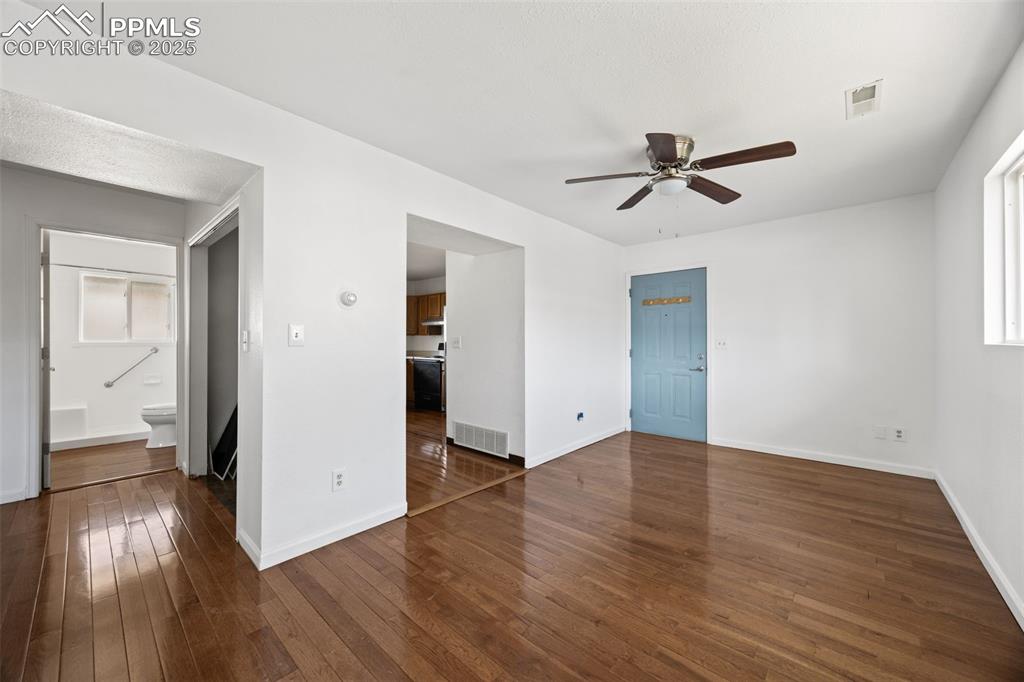 2131 Preuss Road, Unit A Colorado Springs, CO 80910 - Photo 6 of 17 a view of empty room with wooden floor