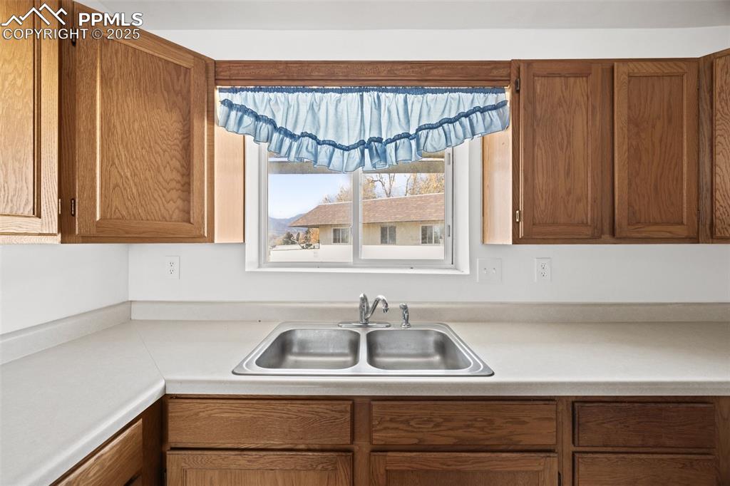 2131 Preuss Road, Unit A Colorado Springs, CO 80910 - Photo 9 of 17 a bathroom with a sink and a mirror