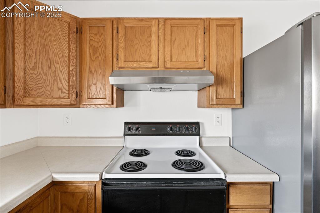 2131 Preuss Road, Unit A Colorado Springs, CO 80910 - Photo 10 of 17 a stove top oven sitting inside of a kitchen