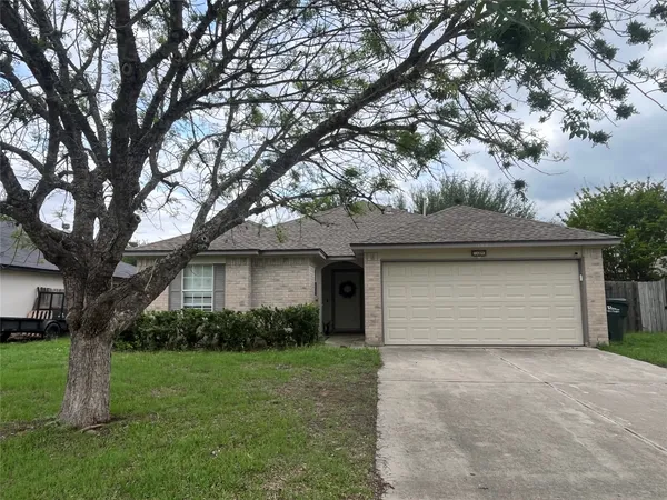 a front view of house with yard and trees