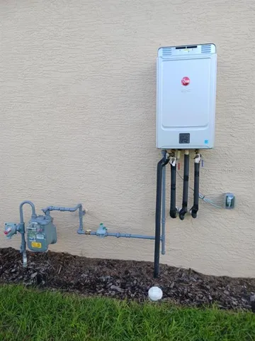 a view of a big house with a big yard and large trees