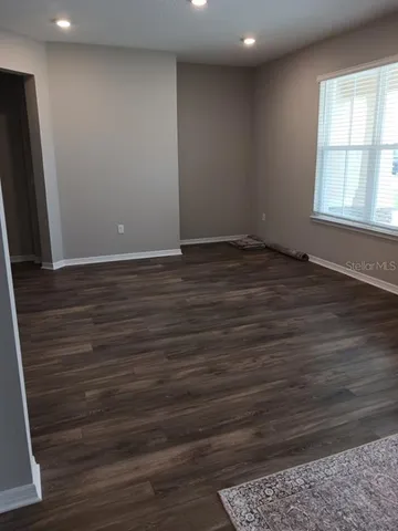 a kitchen with kitchen island granite countertop wooden floors and stainless steel appliances