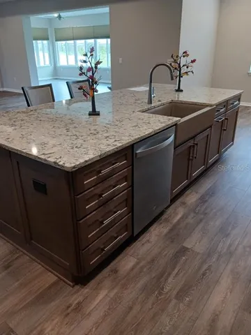 a view of kitchen with wooden floor and electronic appliances