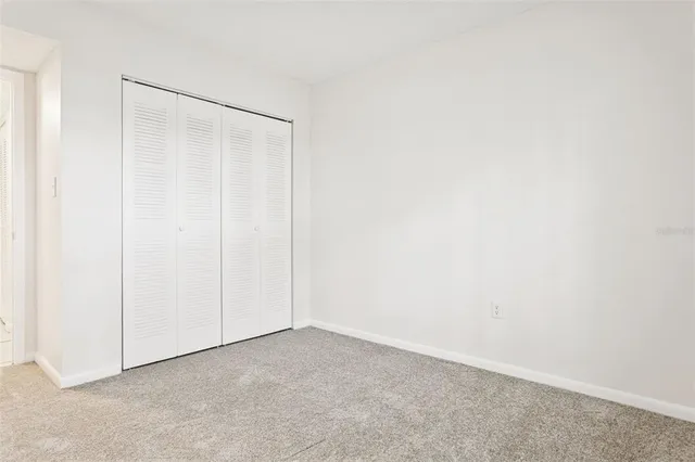 a bathroom with a granite countertop sink a toilet and mirror