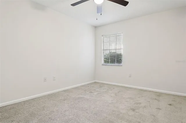 an empty room with a empty space and windows