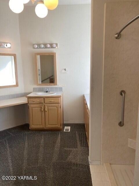 210 North Rivard Road Moxee, WA 98936 - Photo 11 of 18 a bathroom with a sink a toilet and mirror