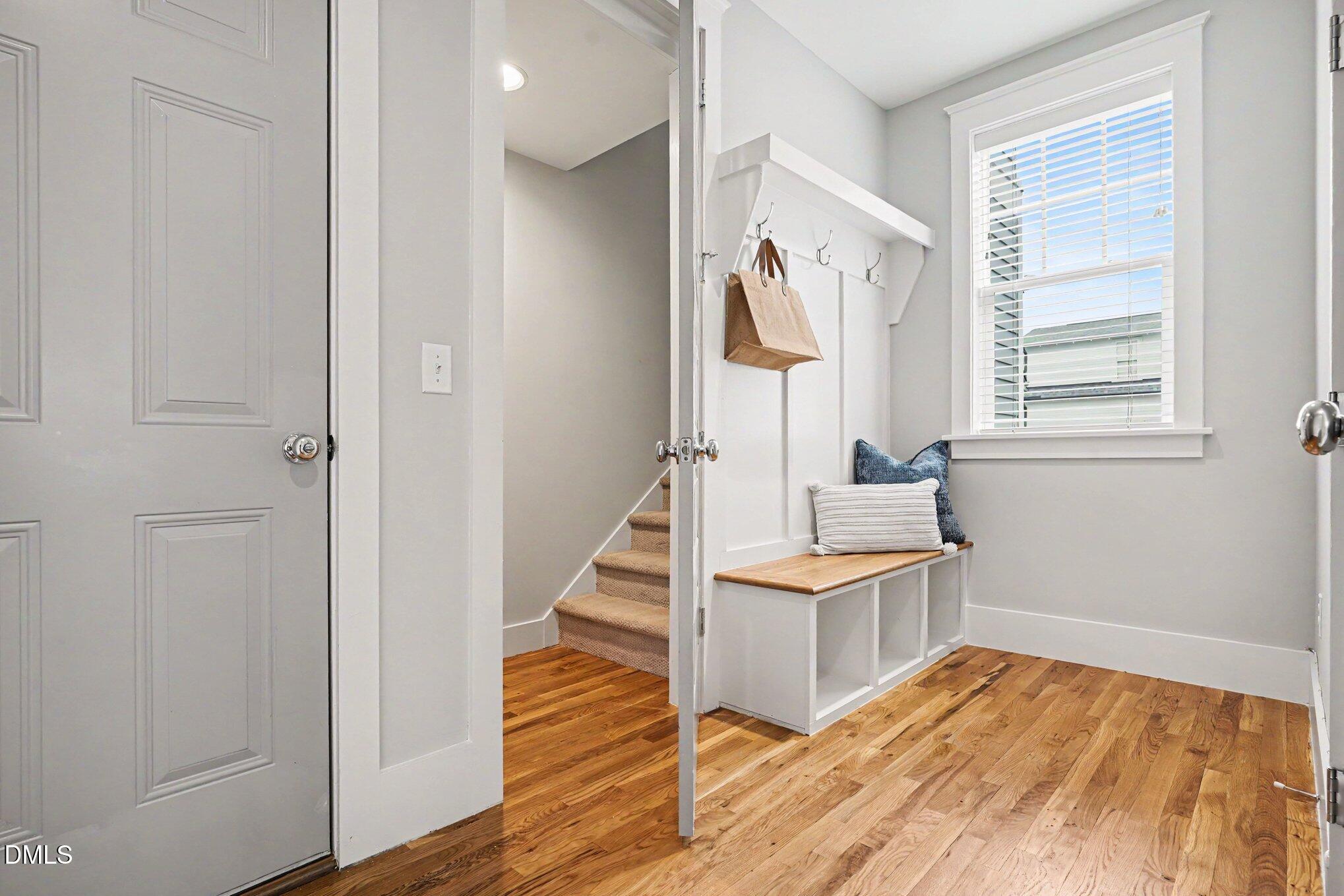 824 Watercolor Way Durham, NC 27713 - Photo 11 of 28 a view of a hallway with wooden floor and staircase
