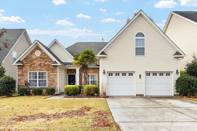 a view of a house with snow on the road