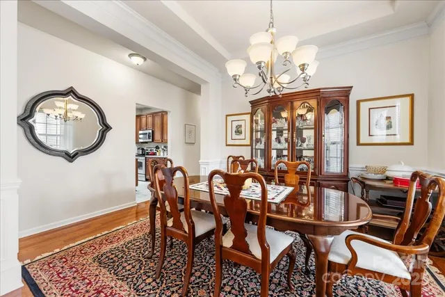 a view of a dining room with furniture and a chandelier