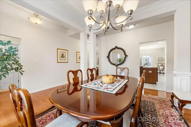 a dining room with furniture and wooden floor