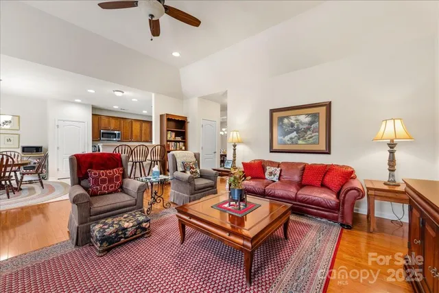 a living room with furniture a rug and a lamp