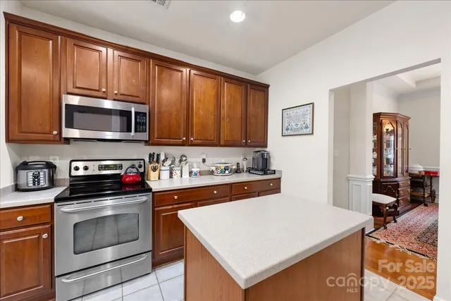 a kitchen with stainless steel appliances a stove microwave and cabinets