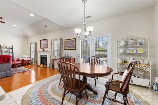 a view of a dining room with furniture wooden floor and chandelier