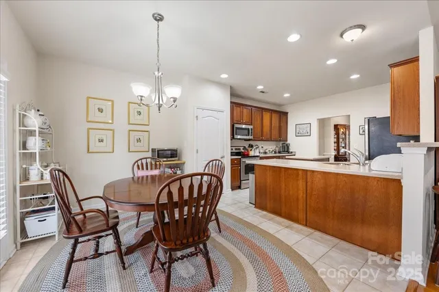 a view of a dining room with furniture and chandelier
