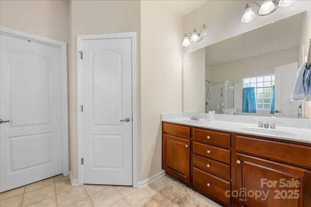 a spacious bathroom with a granite countertop sink a mirror and a
