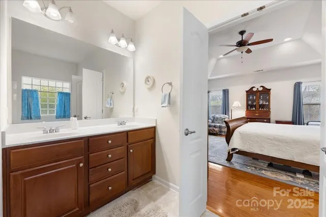 a spacious bathroom with a granite countertop sink and a mirror