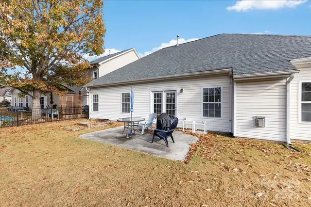 a backyard of a house with outdoor seating
