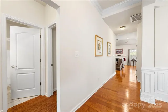 a view of a hallway with wooden floor